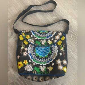 Cute floral embroidered crossbody bag. It measures about 10 x 11 inches